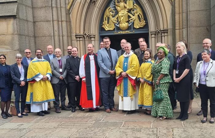 College clergy pose for a photo after the service