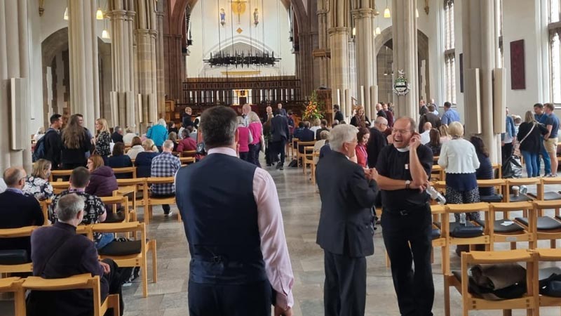 The congregation socialise in the nave after the service